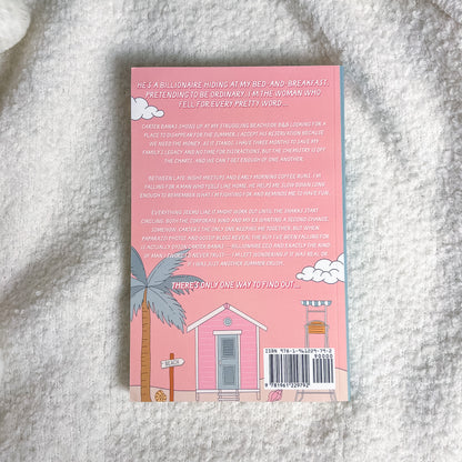 Back cover of a book with pink design and text on a textured surface