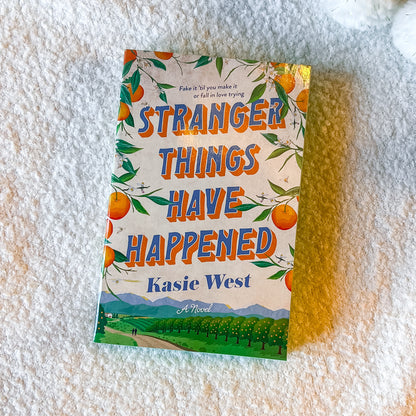 The book “stranger things have happened” with a rural design on a textured white surface