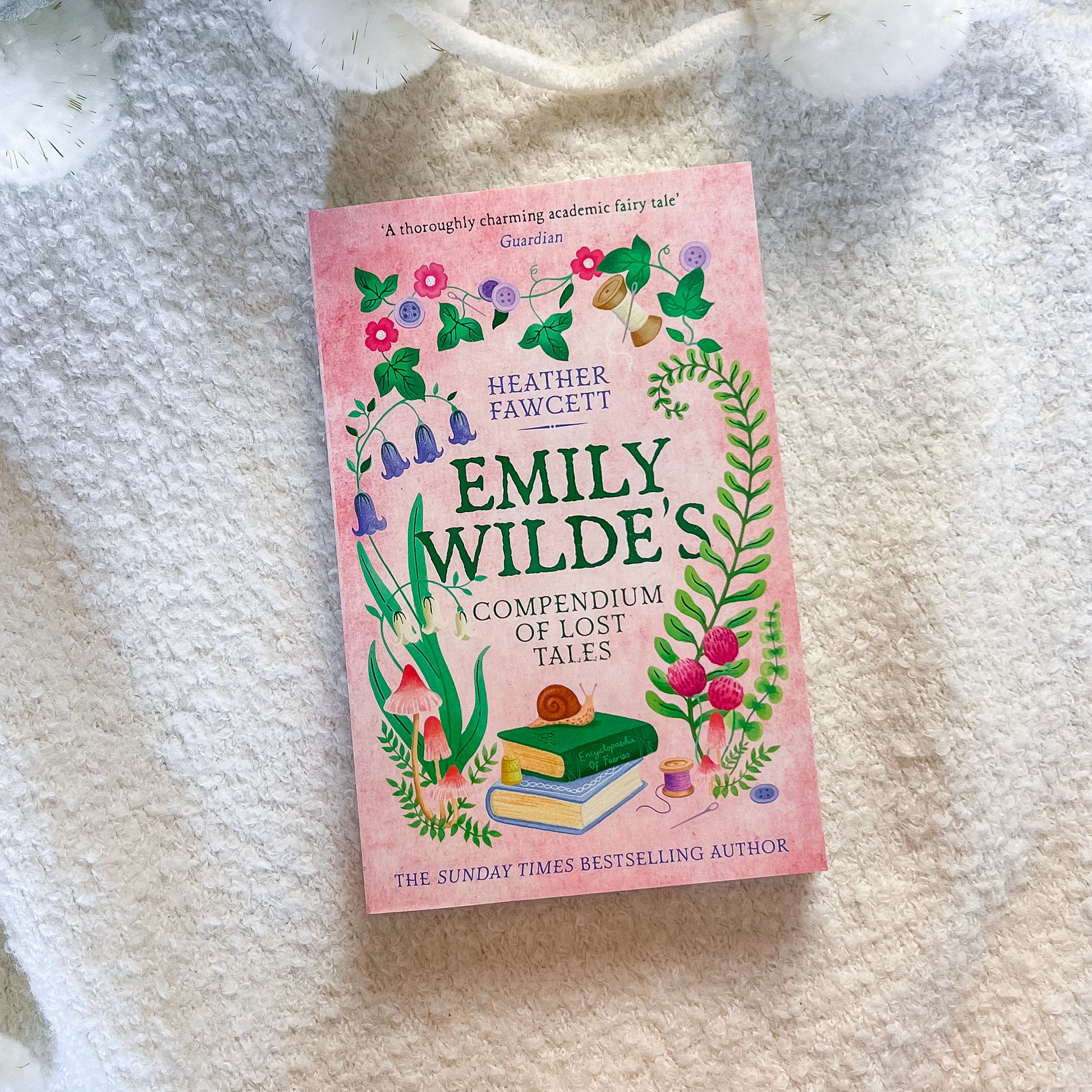 Book titled 'Emily Wilde's Compendium of Lost Tales' on a textured surface