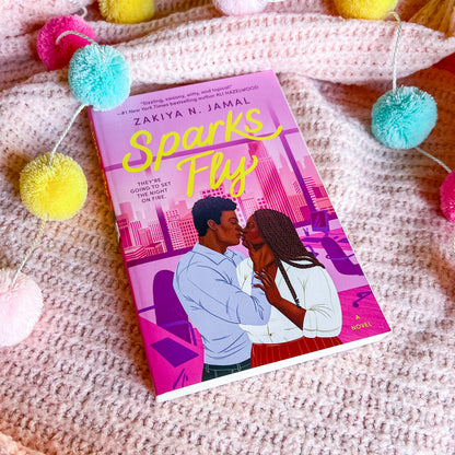 "Sparks fly" book by Zakiya N Jamal, which shows a couple embracing, on a pink background