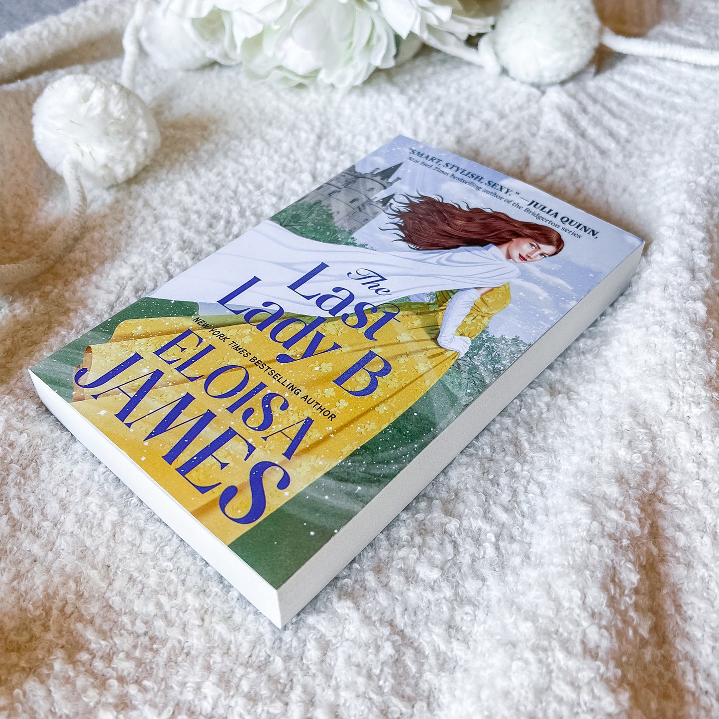 Book cover of 'The Last Lady B' by Eloisa James with a woman in a yellow dress and castle in the background.