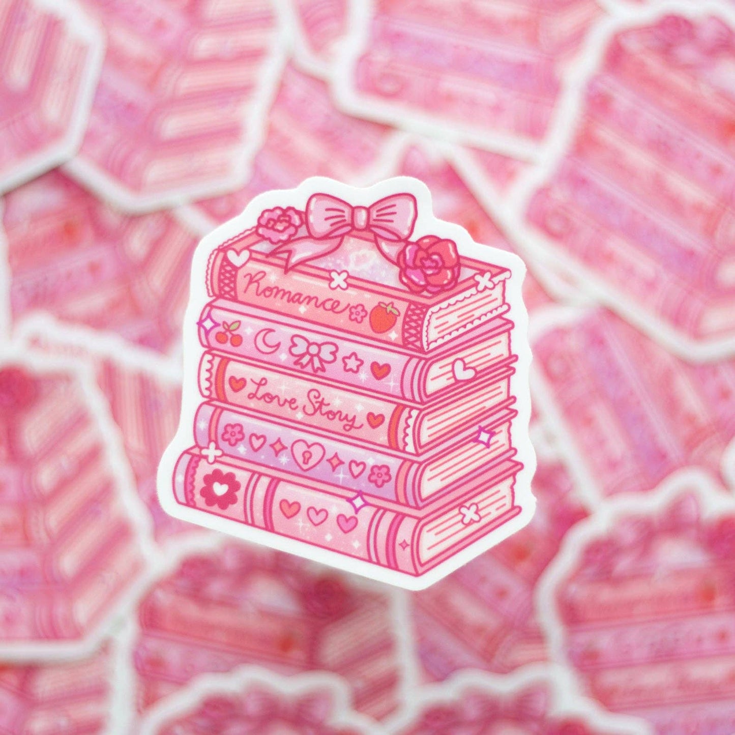 Pink sticker with books and a bow on a pink patterned background