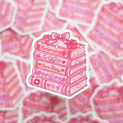 Pink sticker with books and a bow on a pink patterned background