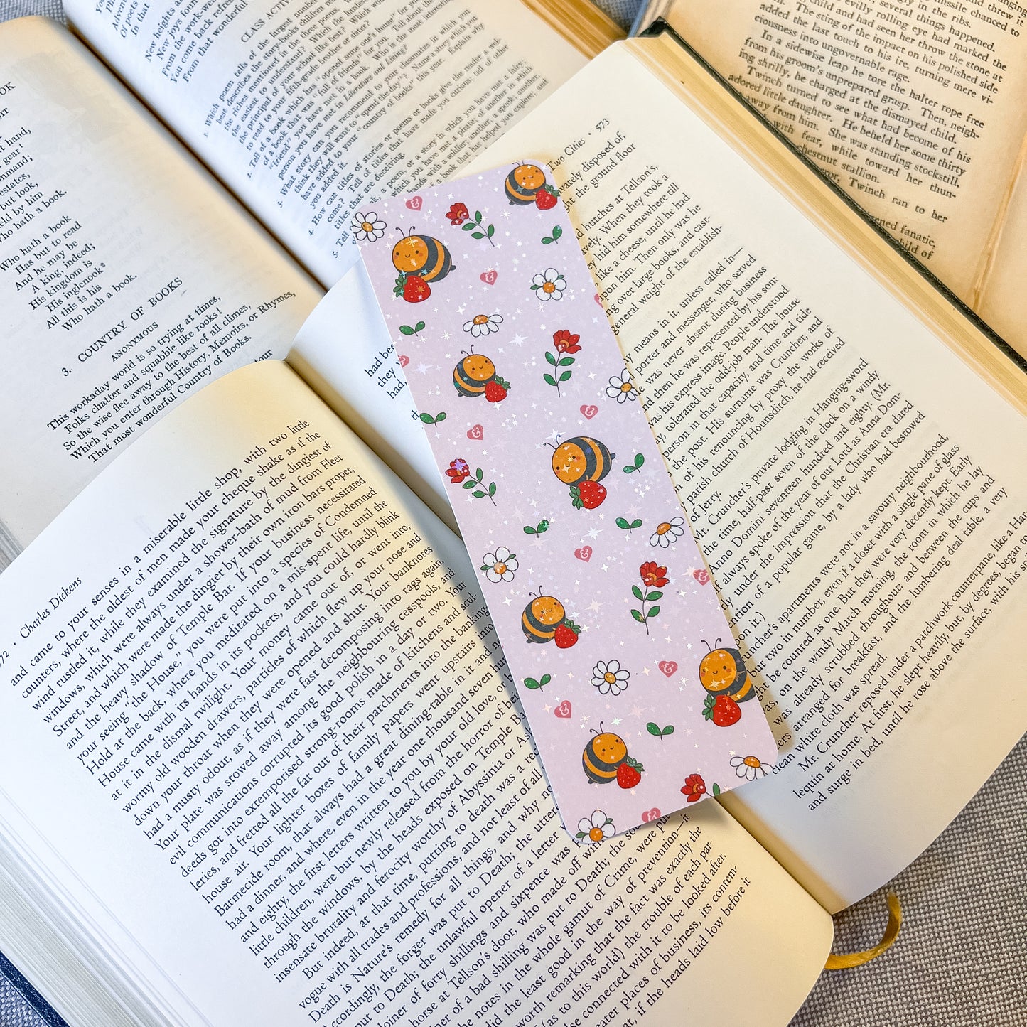Book with a decorative bookmark featuring cartoon characters and flowers on an open book.