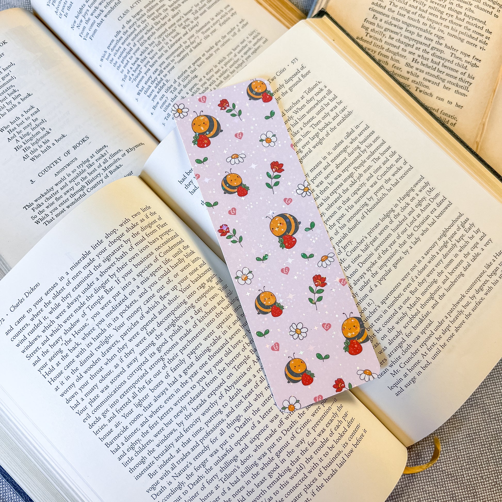 Book with a decorative bookmark featuring cartoon characters and flowers on an open book.