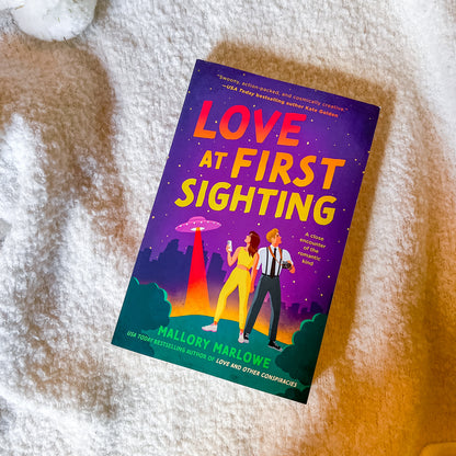 Book titled 'Love at First Sighting' by Mallory Marlowe on a textured surface