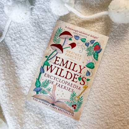 Book titled 'Emily Wildes' Encyclopaedia of Faeries' on a textured surface