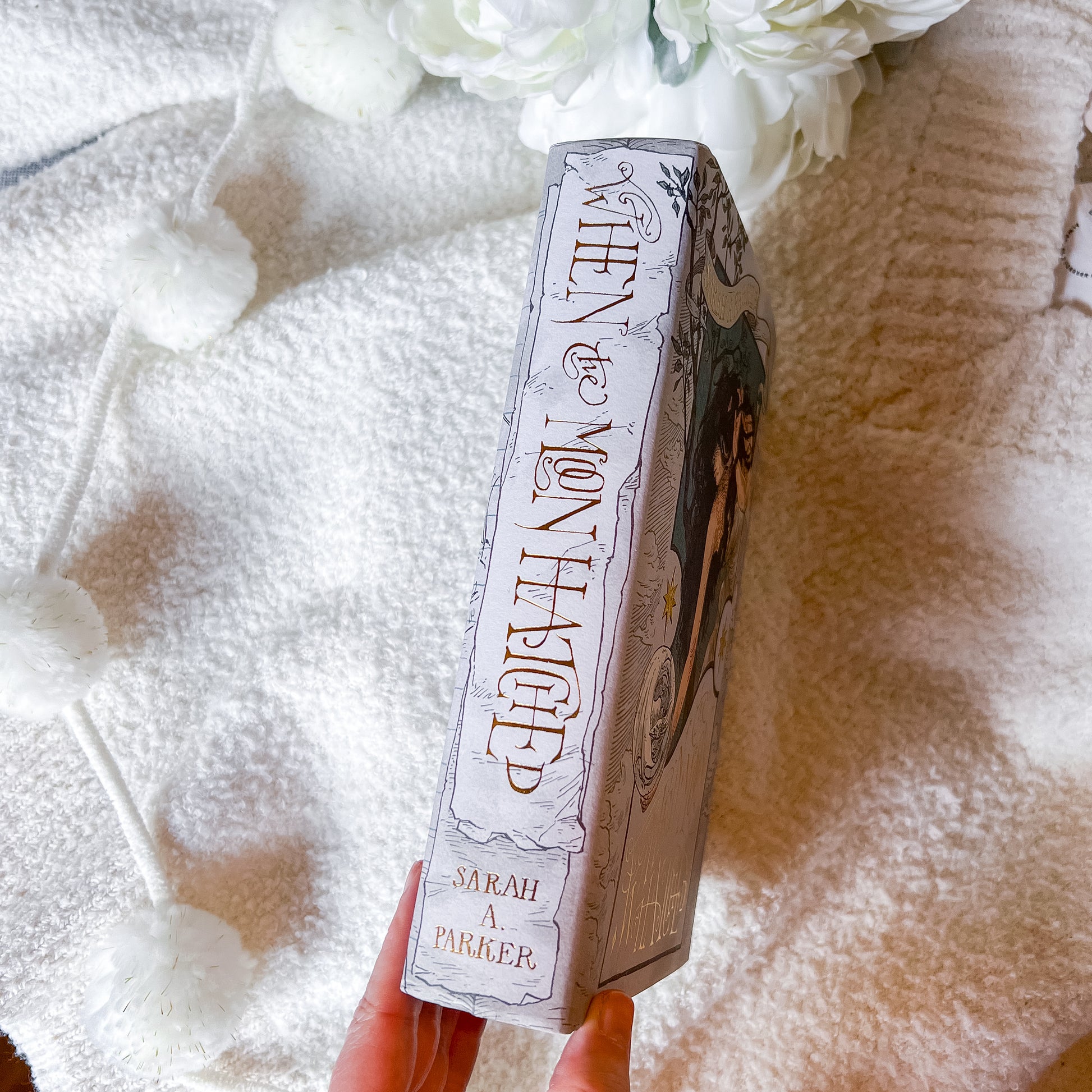 Book titled 'When Moon Hatched' by Sarah A. Parker on a textured white surface.