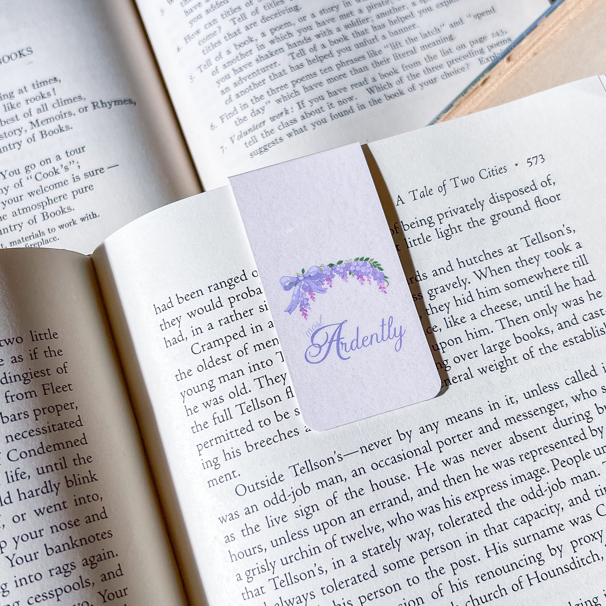 Open book with a bookmark featuring a purple flower design and the word 'Ardently'.