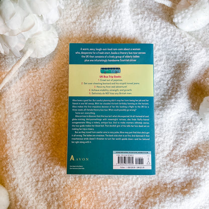 The back cover of a book by Avon, photographed flat on a textured beige and white fabric background.