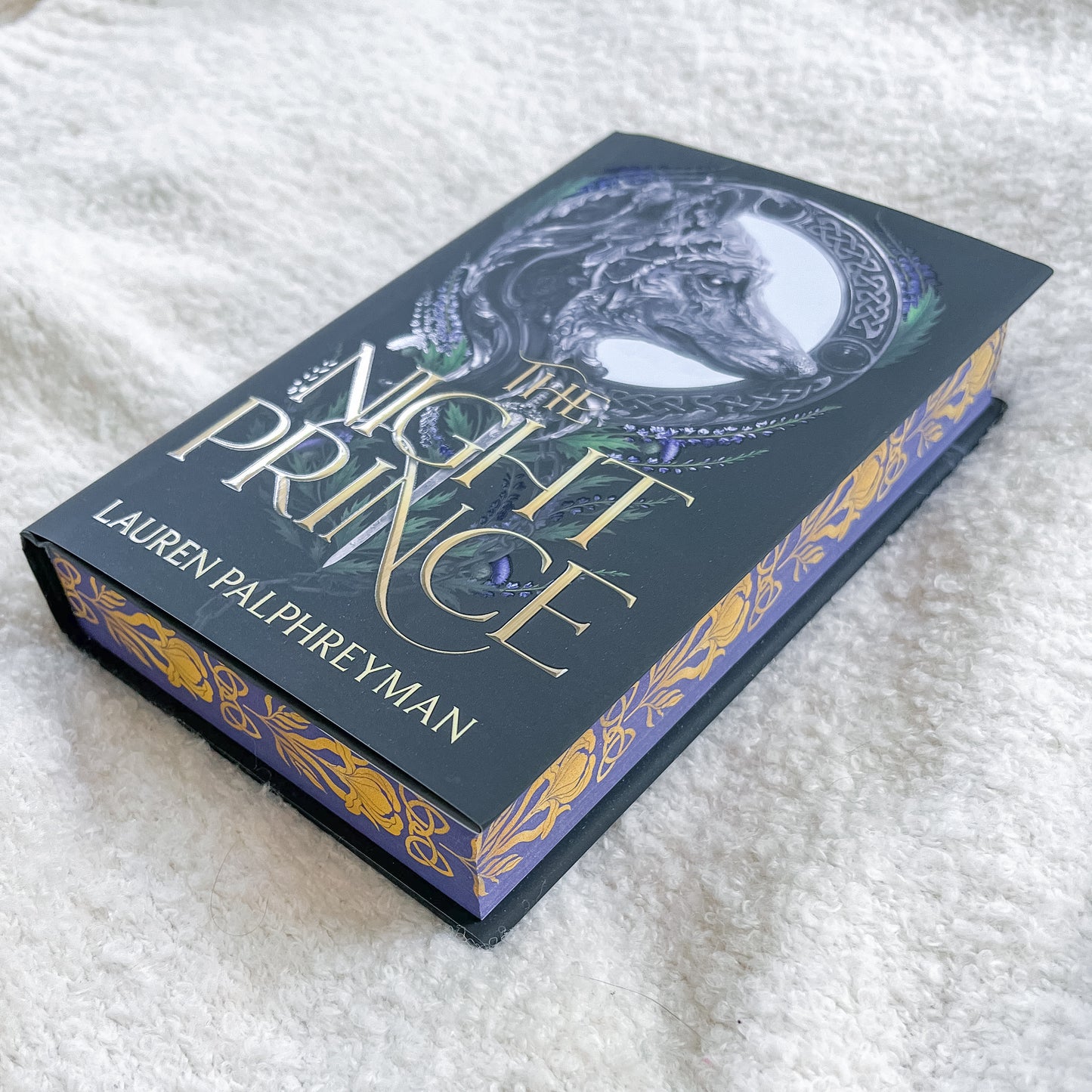 Book titled 'The Night Prince' by Lauren Palphreyman on a white textured surface