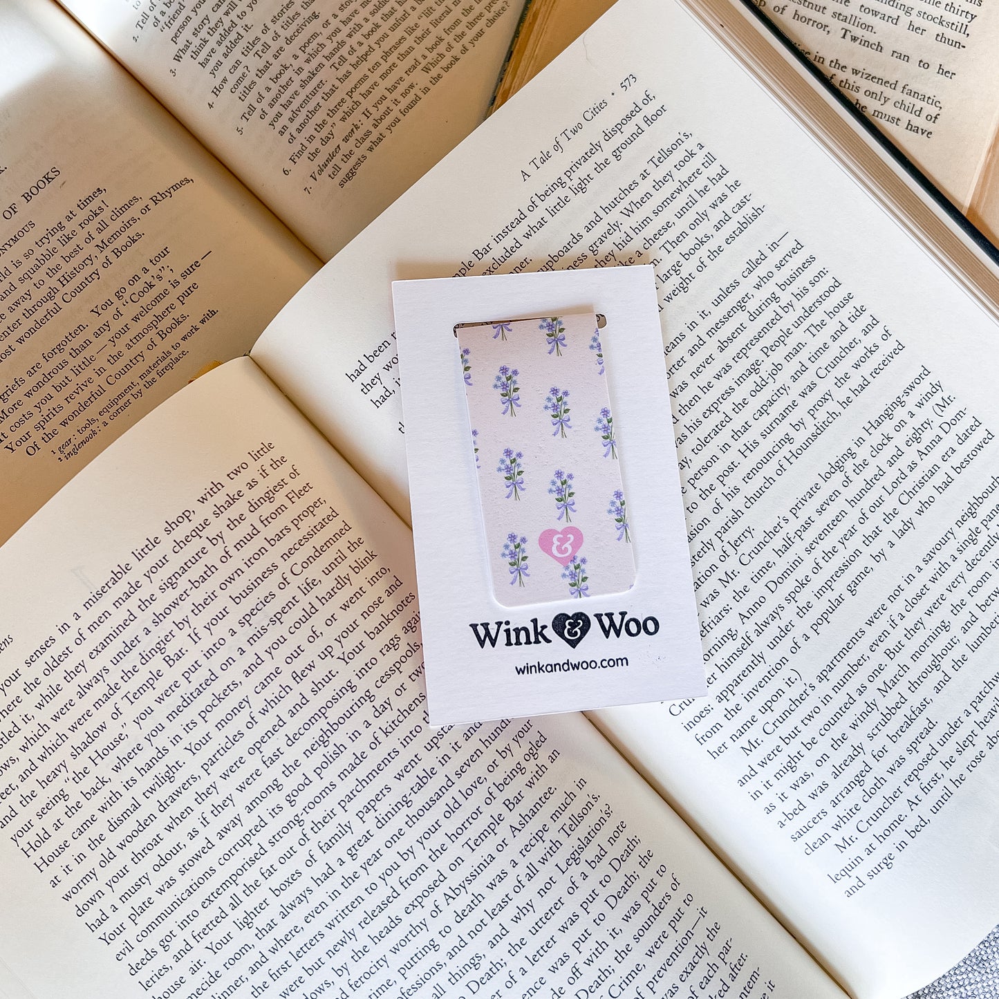 Phone case with floral design in a Wink Woo box on an open book