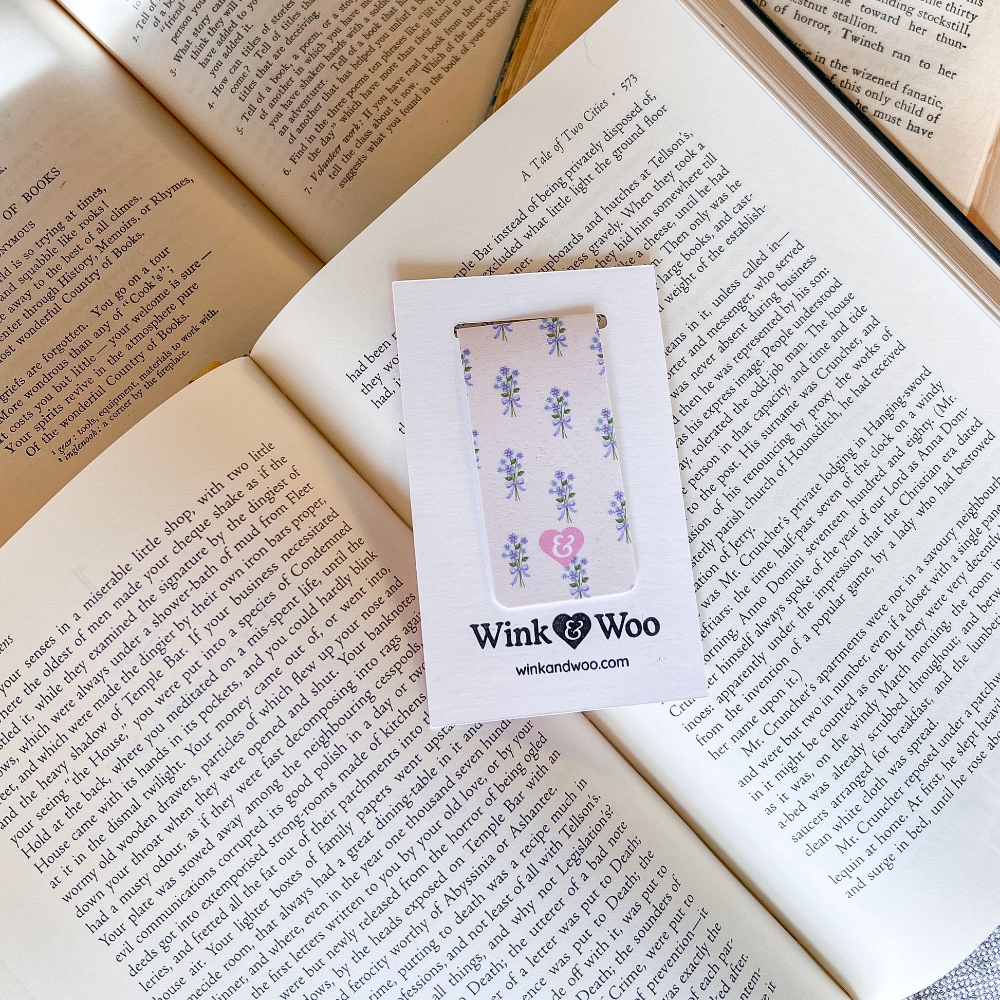 Phone case with floral design in a Wink Woo box on an open book