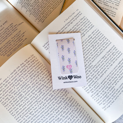 Phone case with floral design in a Wink Woo box on an open book
