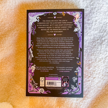 The back cover of the book, displayed flat on a textured beige fabric background.