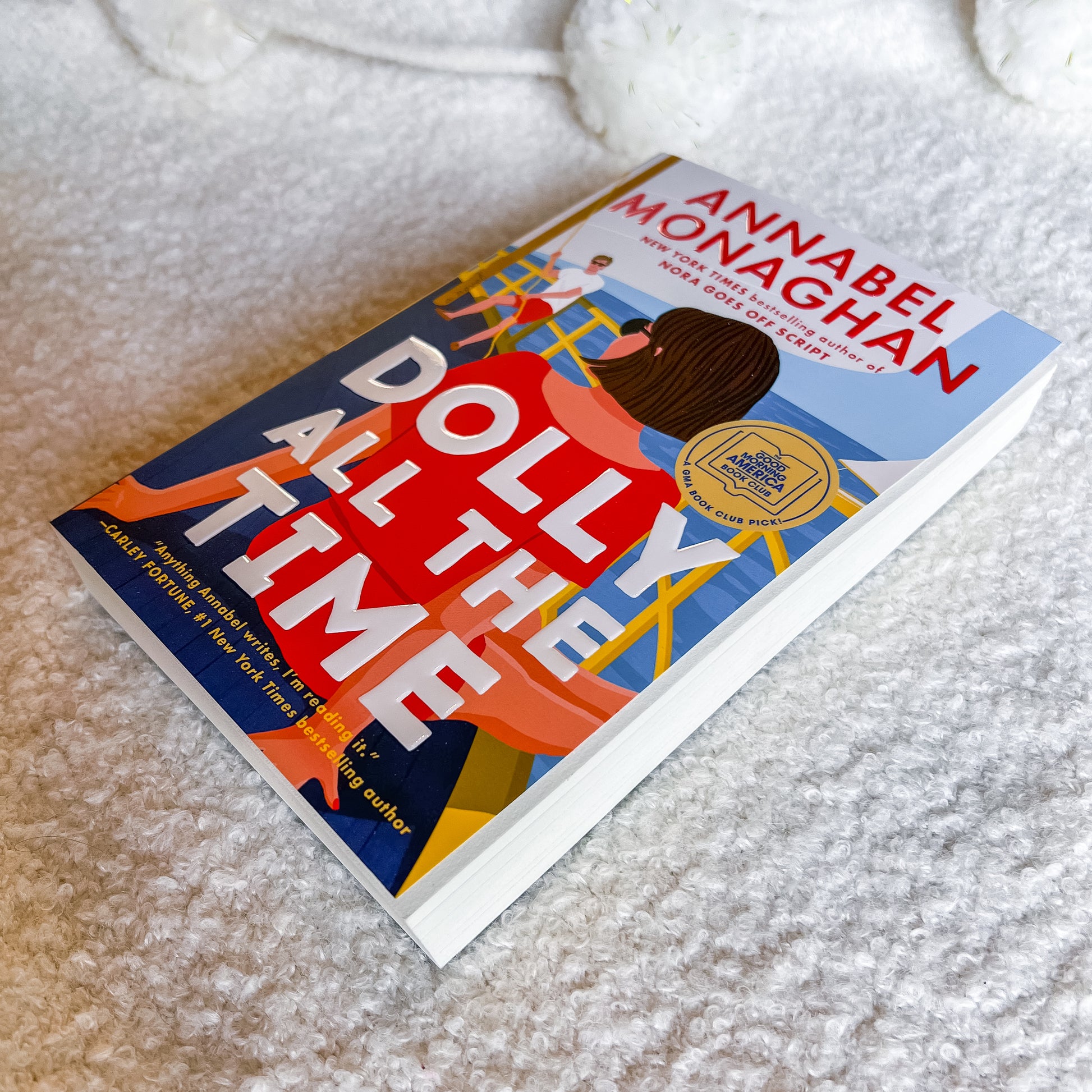 Book titled 'Dolly All the Time' by Annabel Monaghan on a textured surface