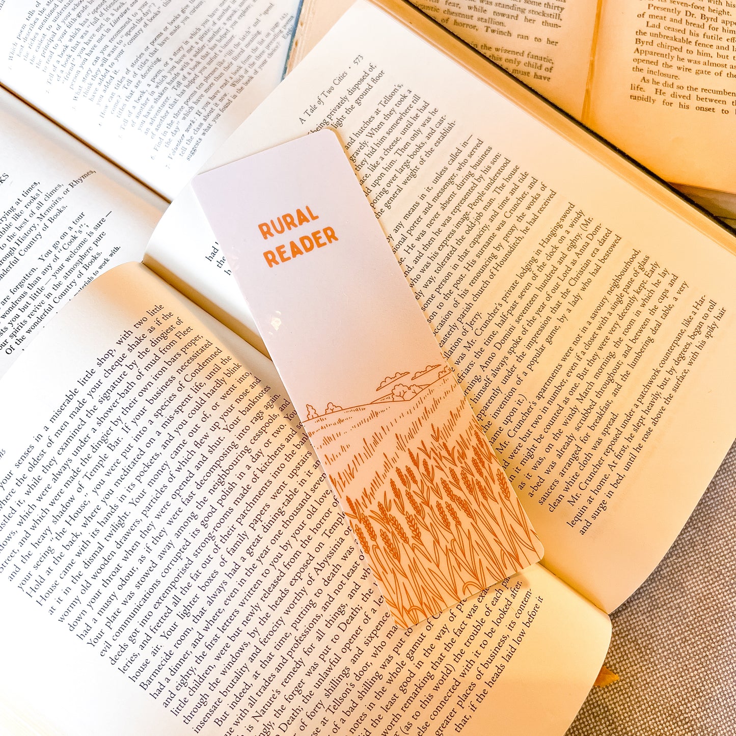 Open book with a bookmark labeled 'Rural Reader' on a wooden surface