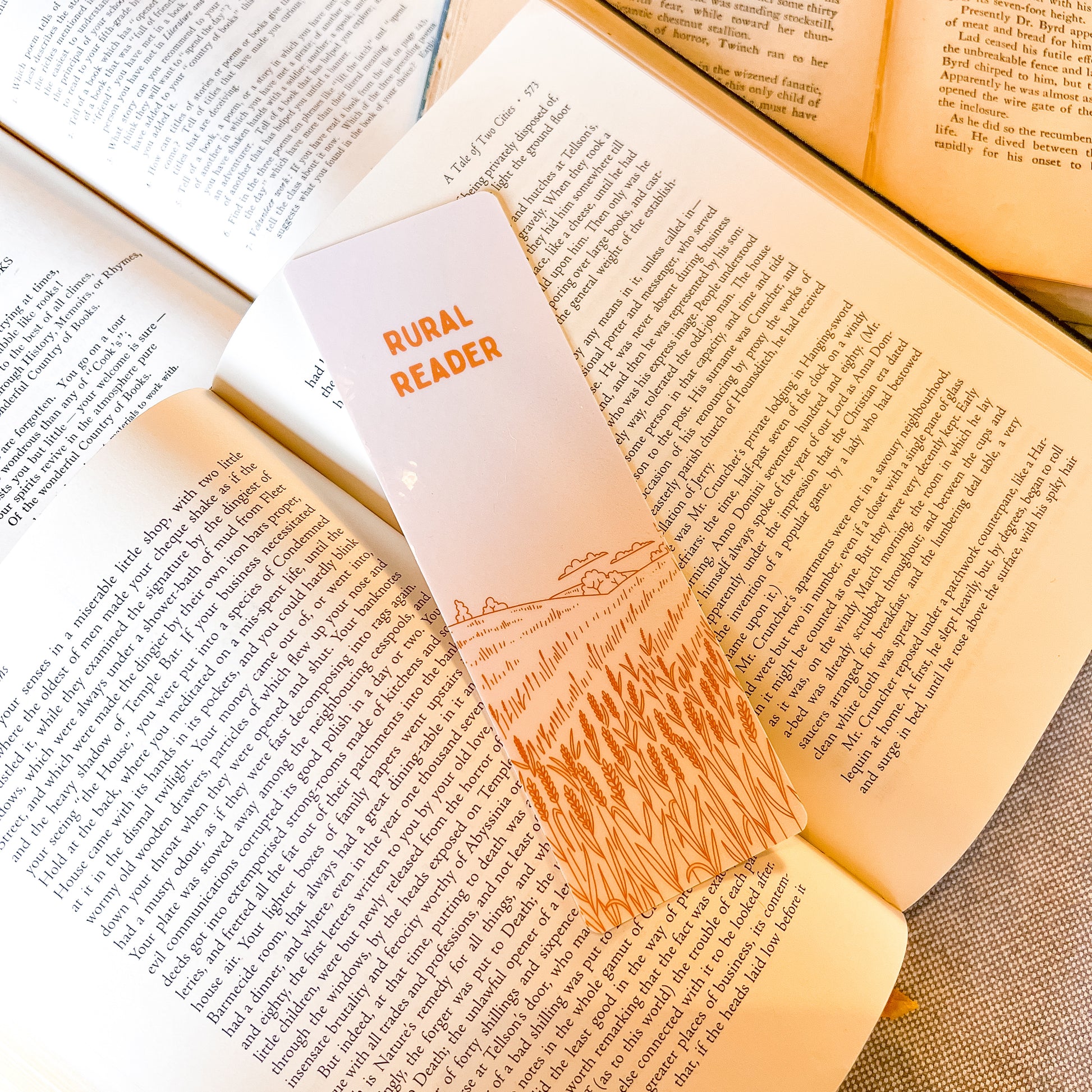 Open book with a bookmark labeled 'Rural Reader' on a wooden surface