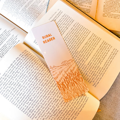 Open book with a bookmark labeled 'Rural Reader' on a wooden surface