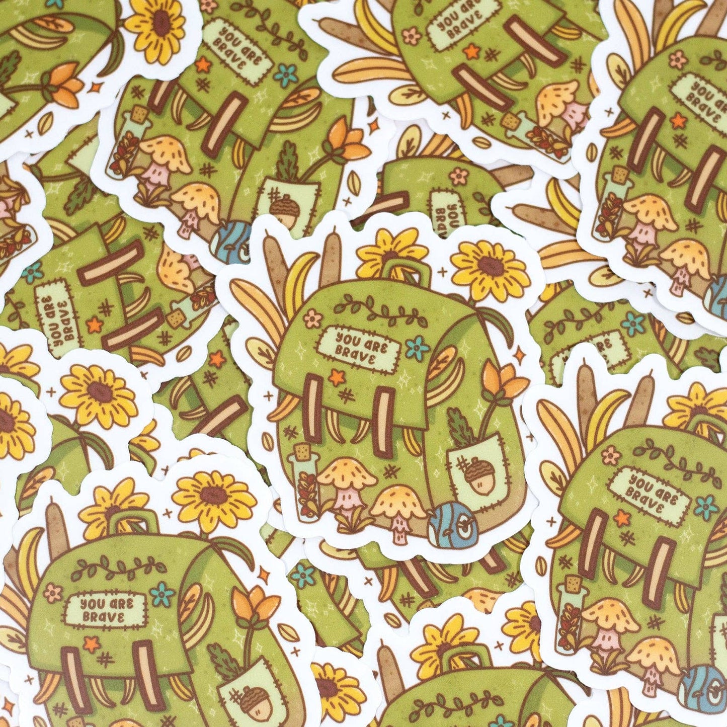 Pattern of green backpacks with cartoon characters and flowers on a white background