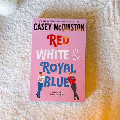 Book titled 'Red, White & Royal Blue' by Casey McQuiston on a white background