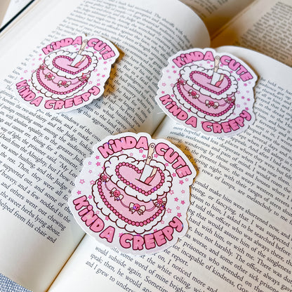 Three 'Kinda Cute Kinda Creepy' stickers on an open book