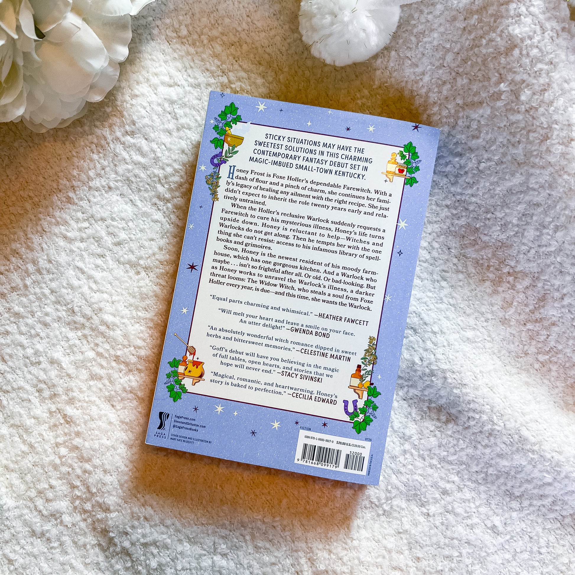 The back cover of a children's book titled 'Sticky Situations' is shown flat-lay on a soft white textured blanket, with a white flower prop in the top-left corner.