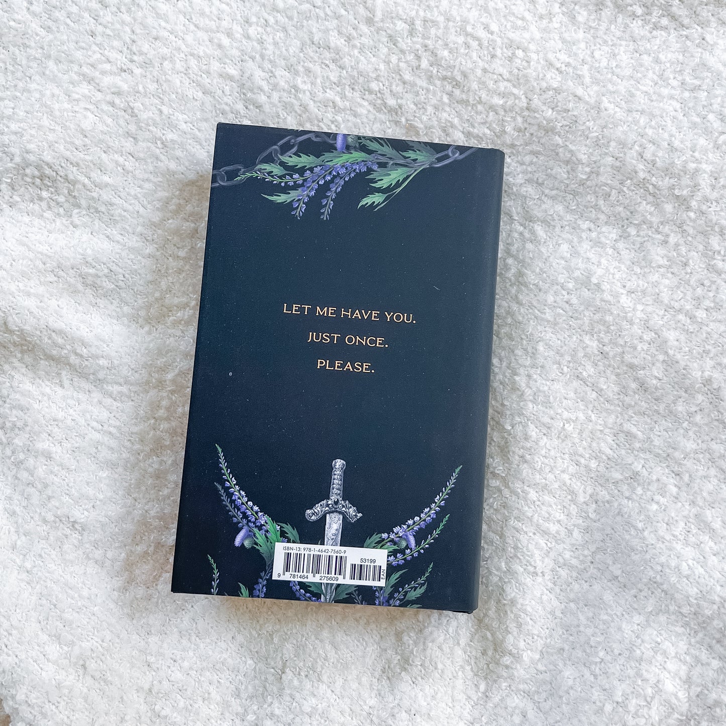 Book with decorative cover and text on a textured white surface