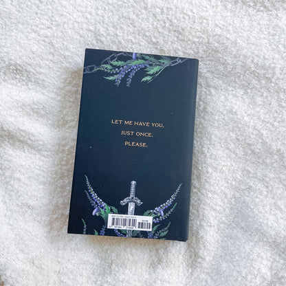 Book with decorative cover and text on a textured white surface