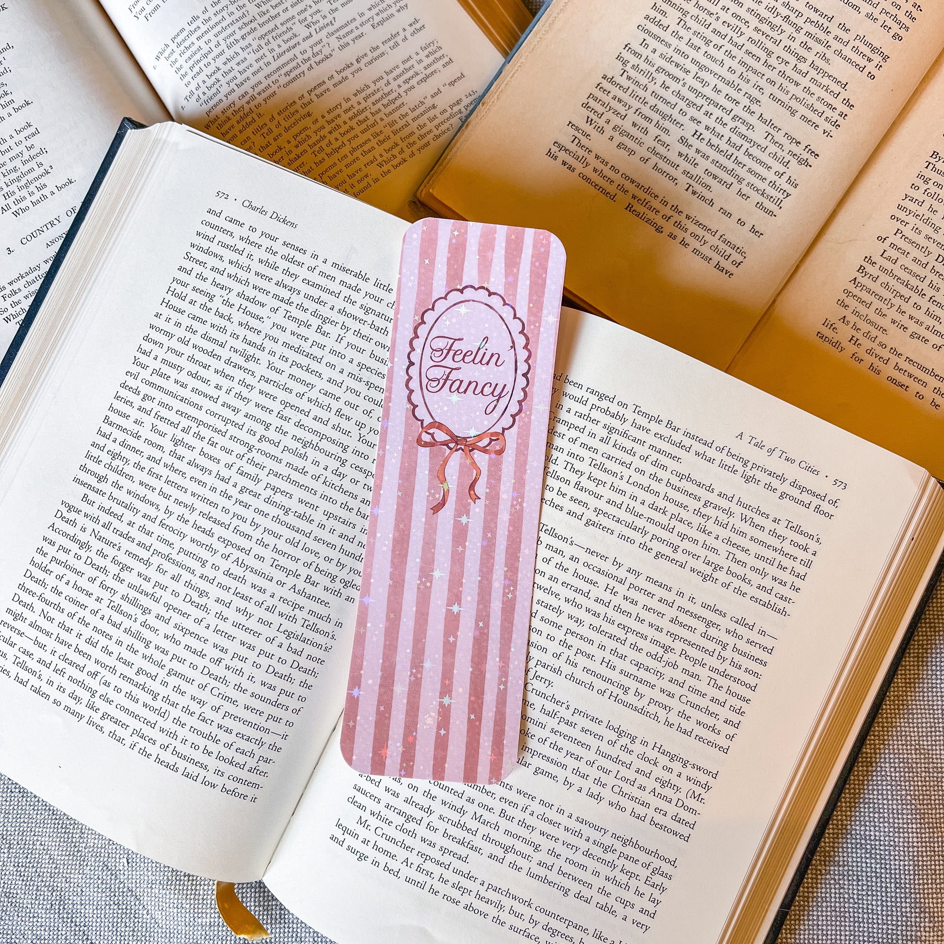 Pink striped bookmark with 'Feelin' Fancy' text on an open book