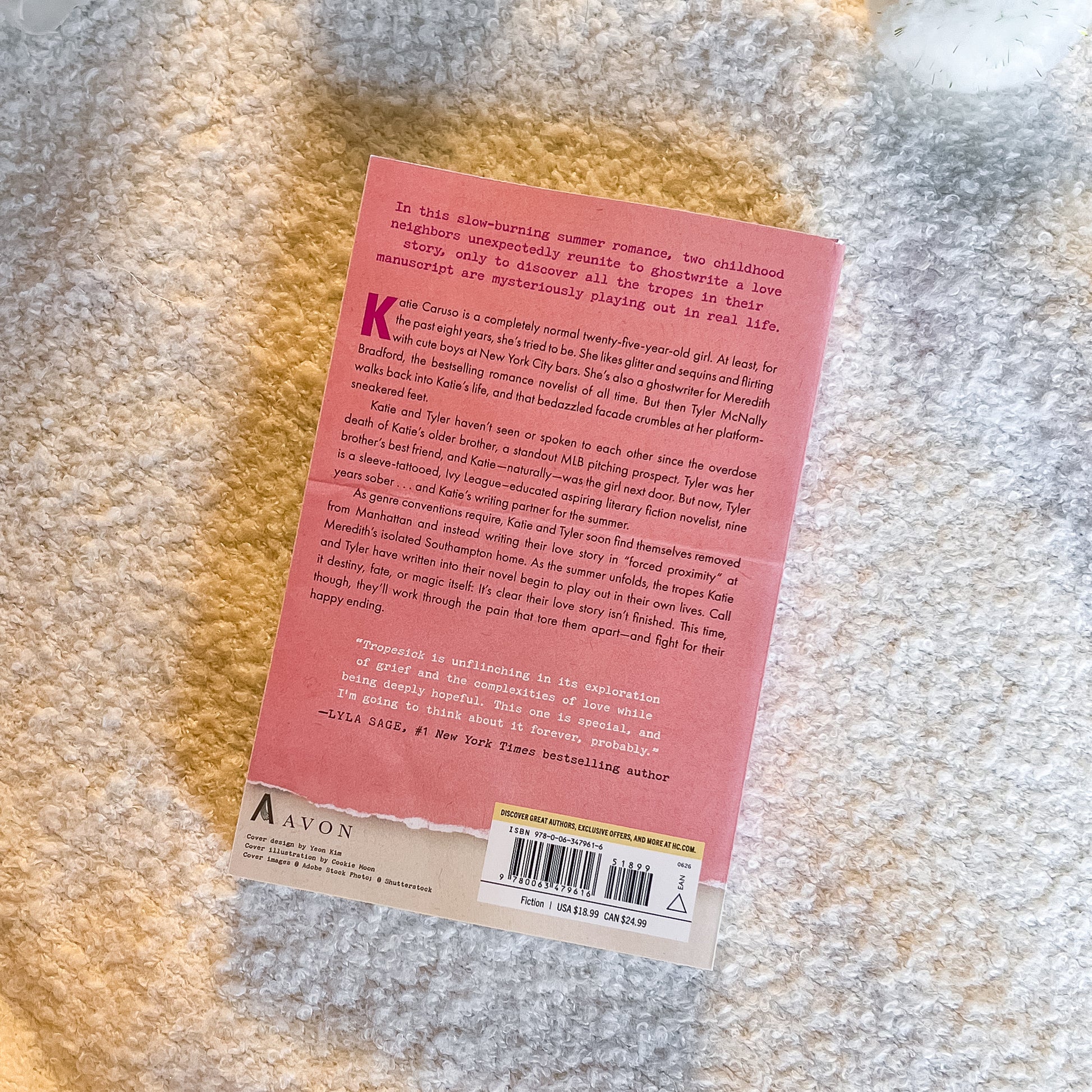Back of a book with a pink label on a textured surface