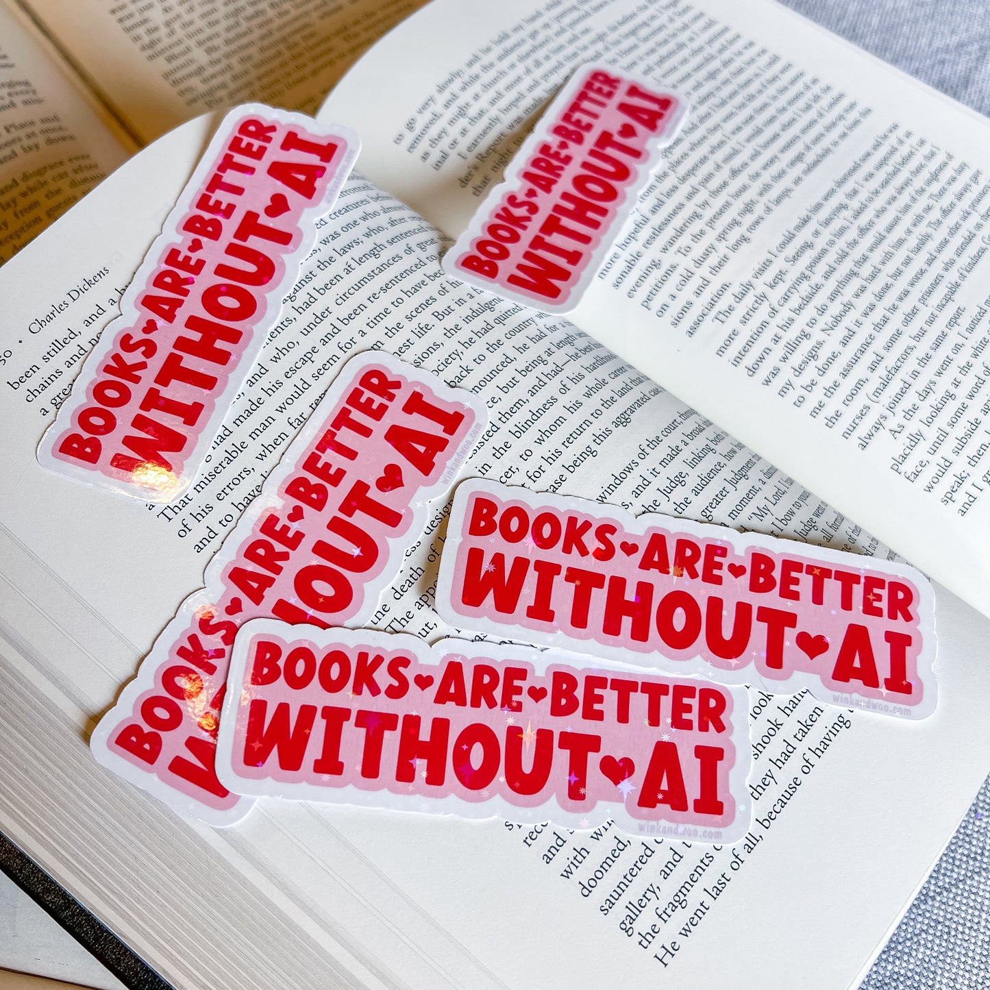 Multiple 'Books are better without AI' stickers on an open book