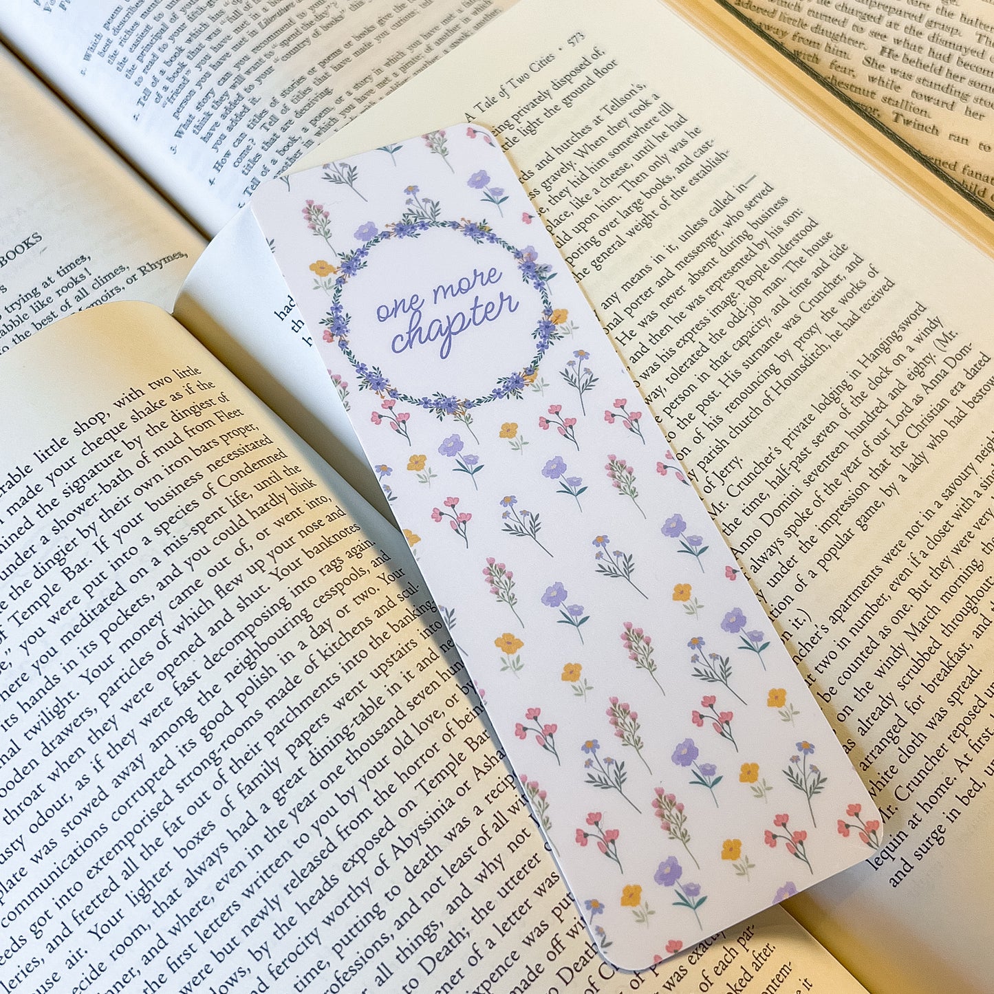 Floral bookmark with 'one more chapter' text on an open book