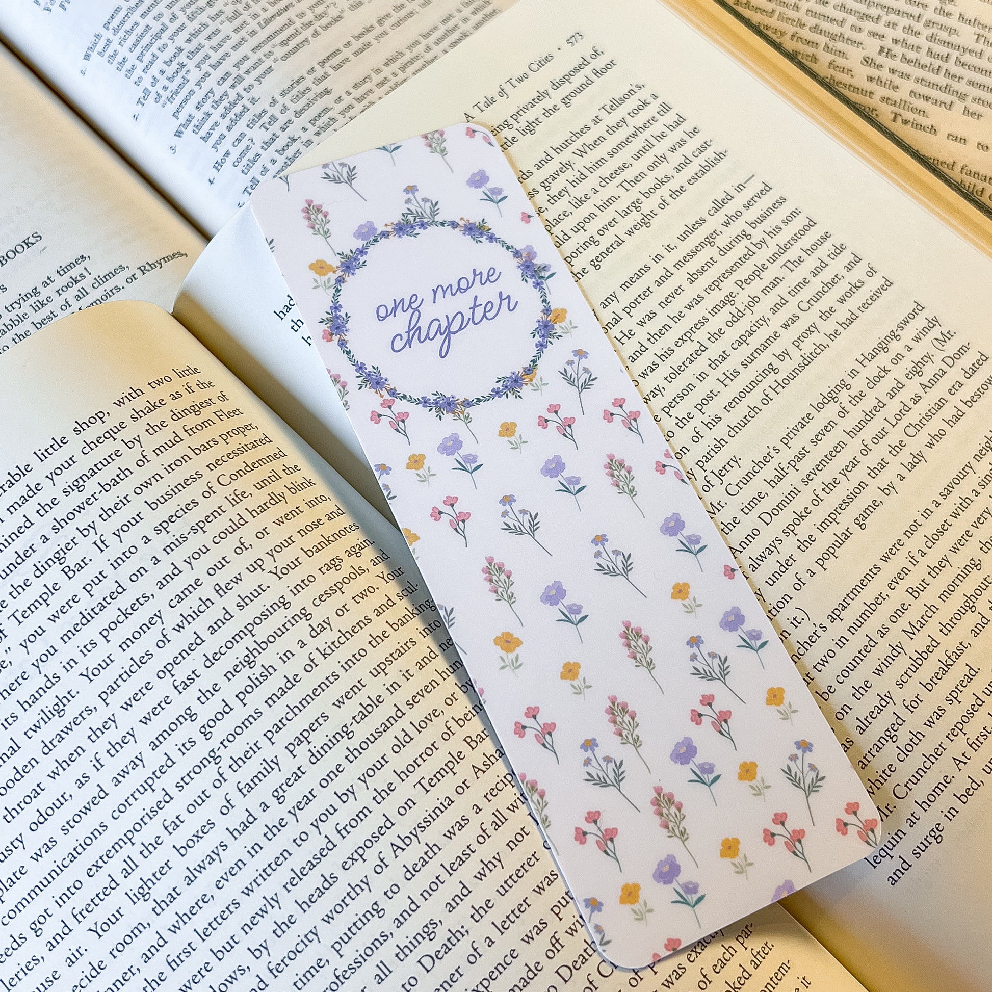 Floral bookmark with 'one more chapter' text on an open book