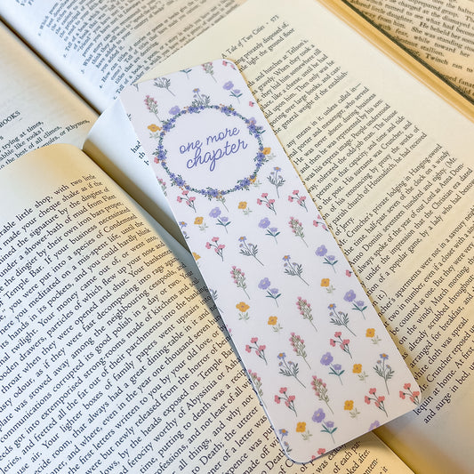 Floral bookmark with 'one more chapter' text on an open book