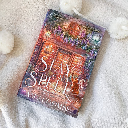 Book titled 'Stay for a Spell' by Amy Coombe on a soft white surface
