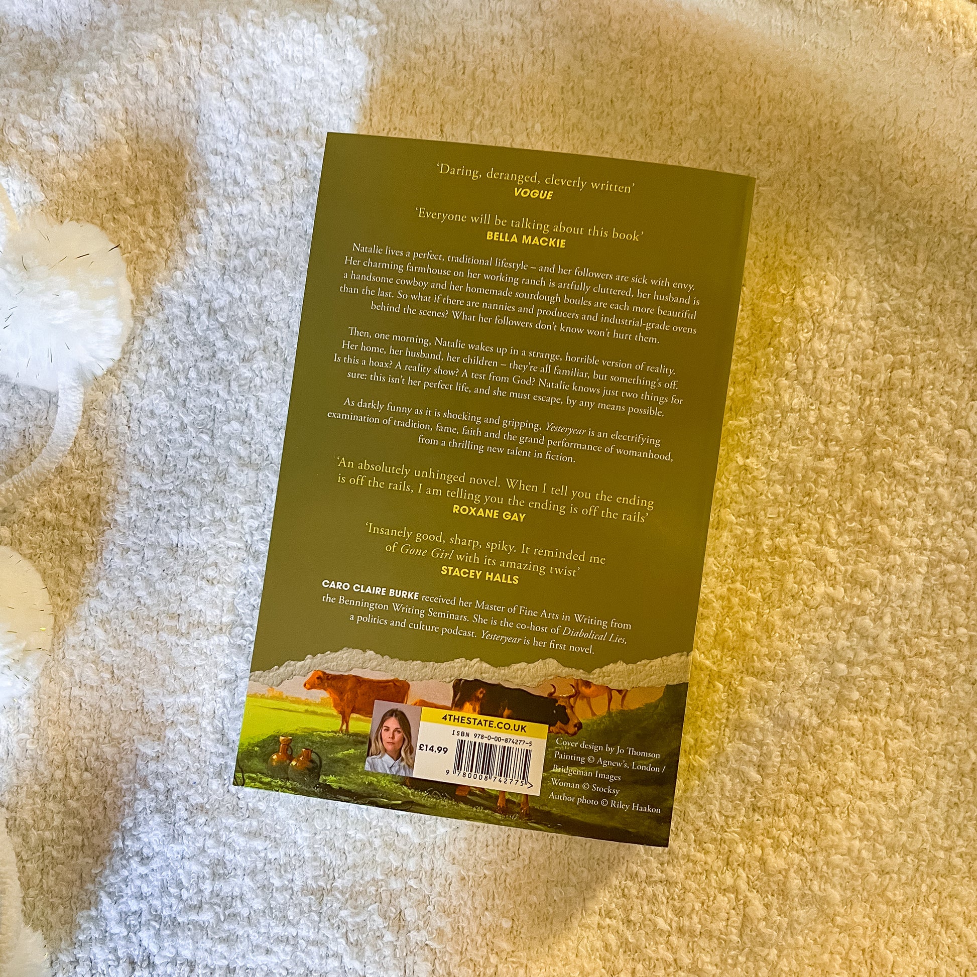 Book cover with text and images of cows on a textured surface