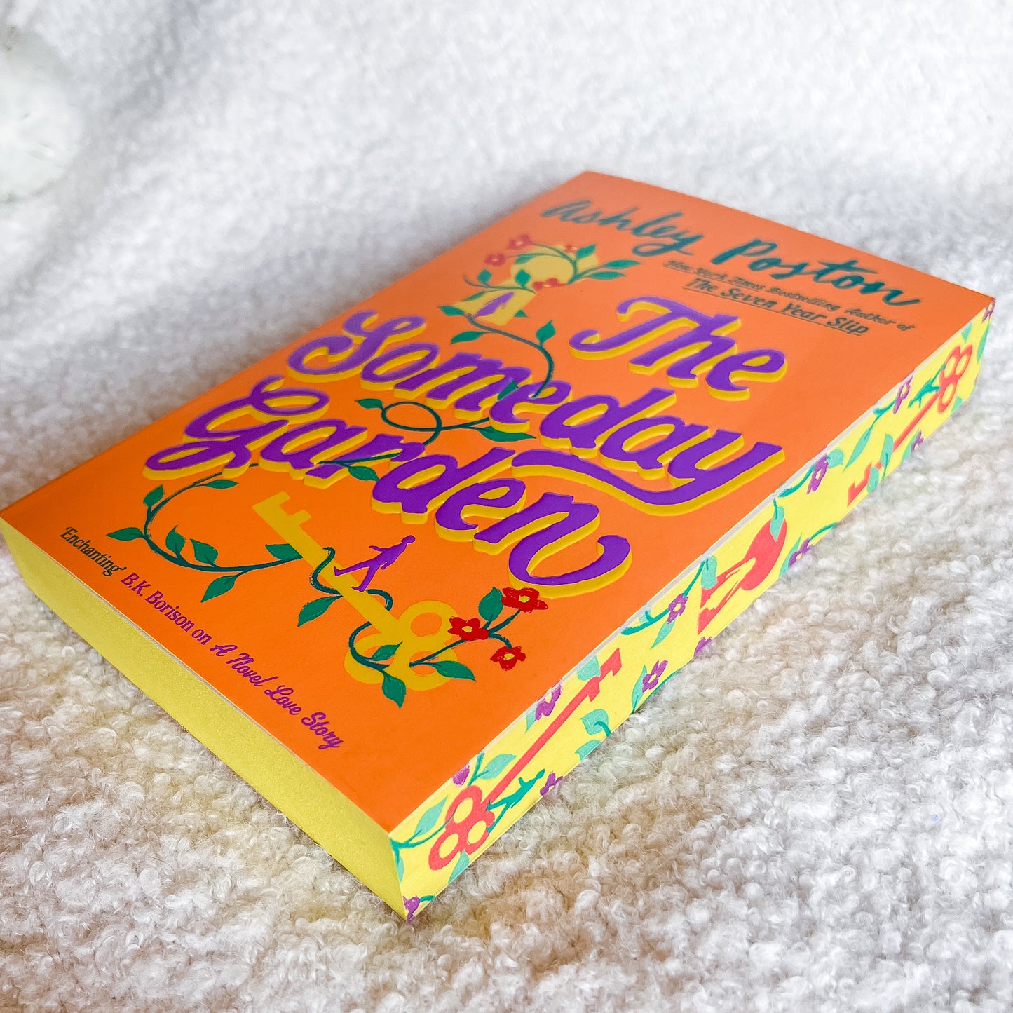 Book titled 'The Someday Garden' on a textured white surface