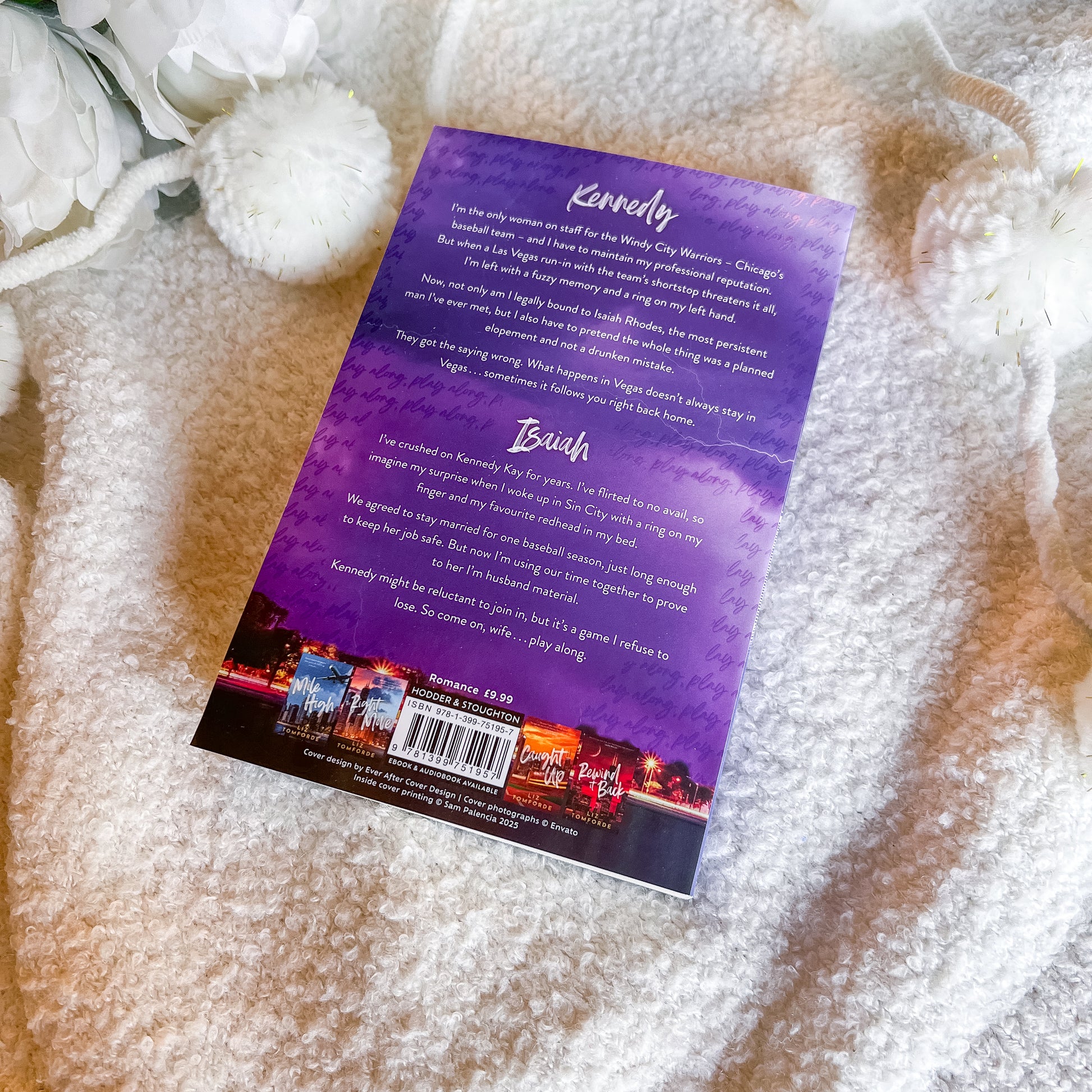 Back cover of a book with text and a barcode on a textured surface with white flowers.