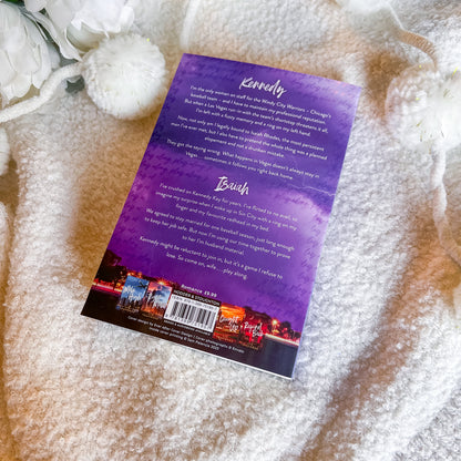 Back cover of a book with text and a barcode on a textured surface with white flowers.