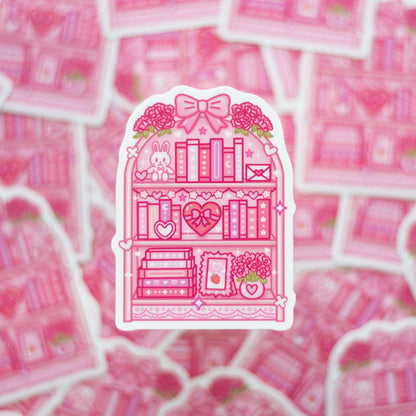 Pink sticker with a bookshelf design on a pink background