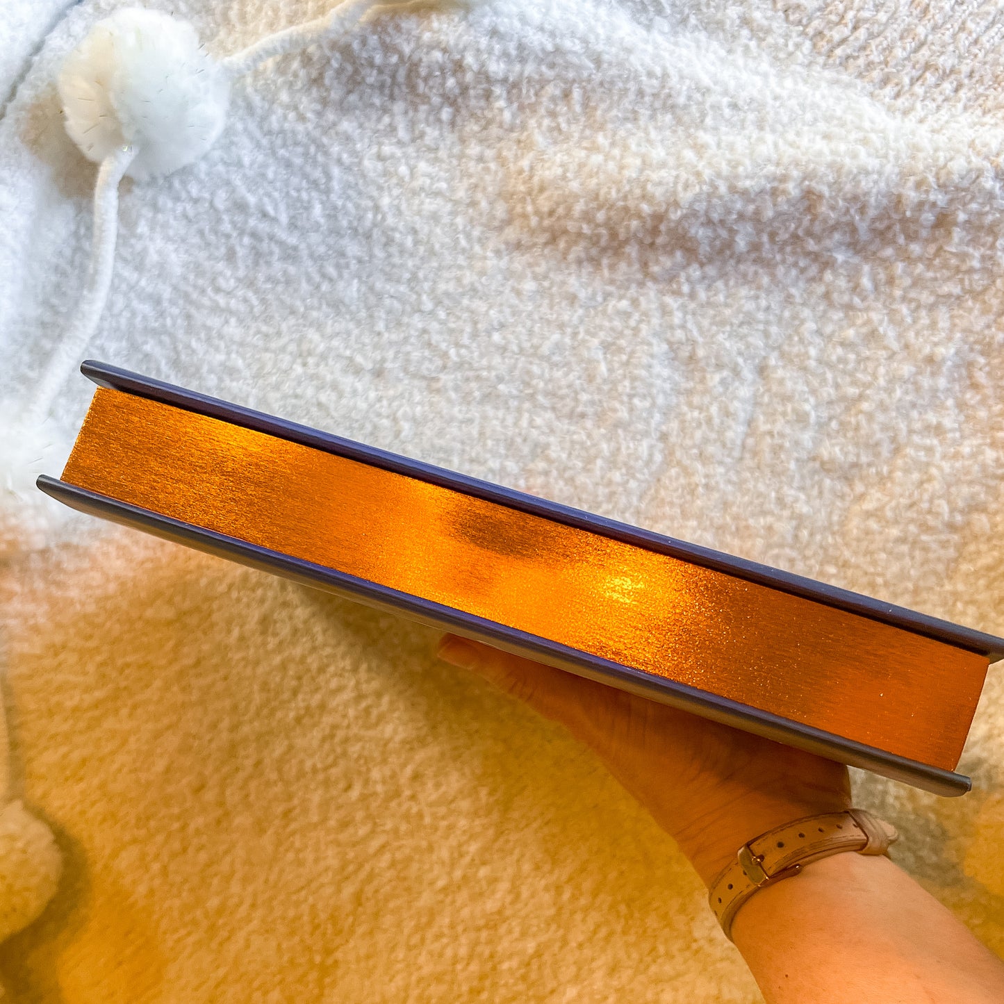 Metallic book on a textured surface