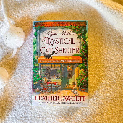 Book titled 'Mystical Cat Shelter' by Agnes Aubert and Heather Fawcett on a white background