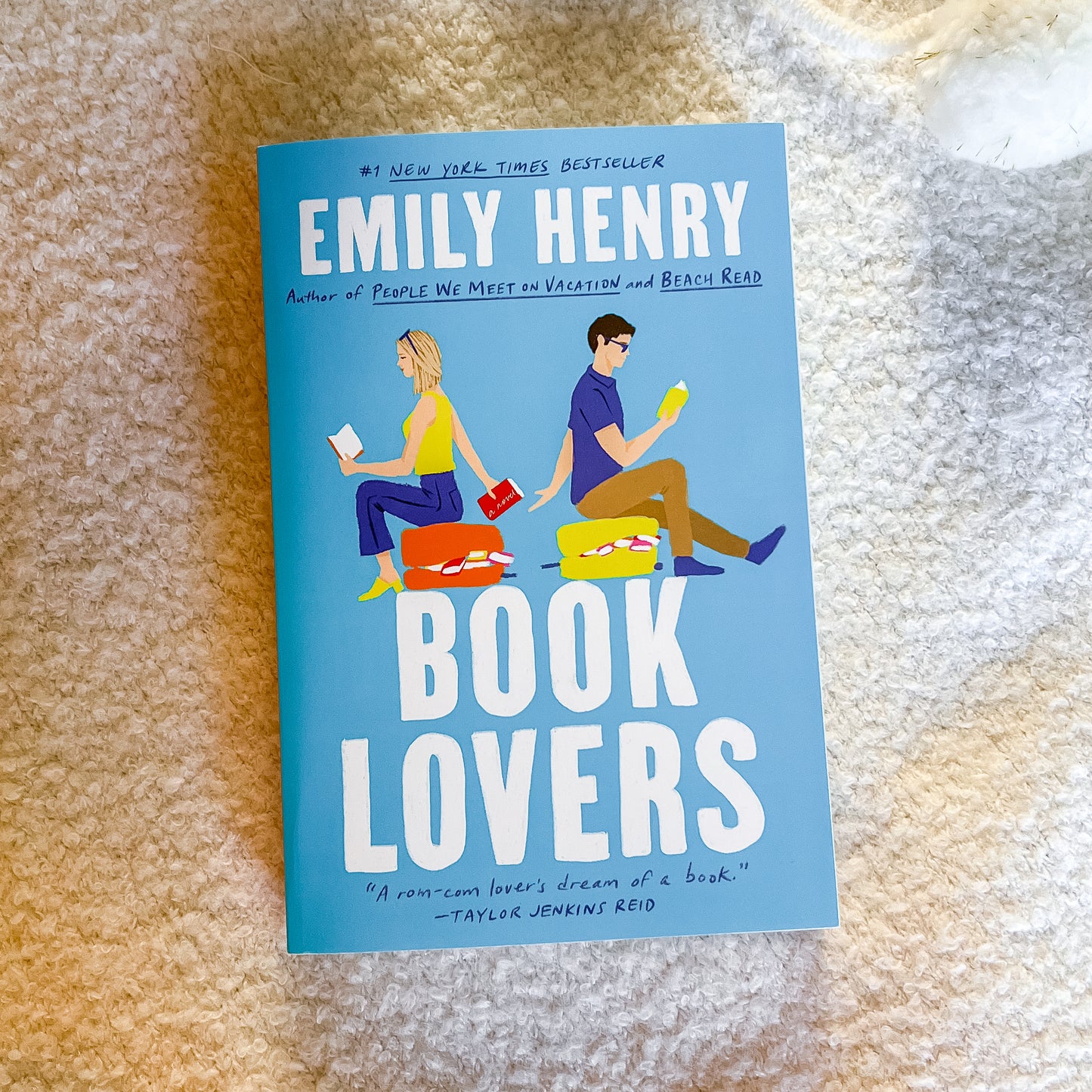 Book cover of 'Book Lovers' by Emily Henry on a textured surface