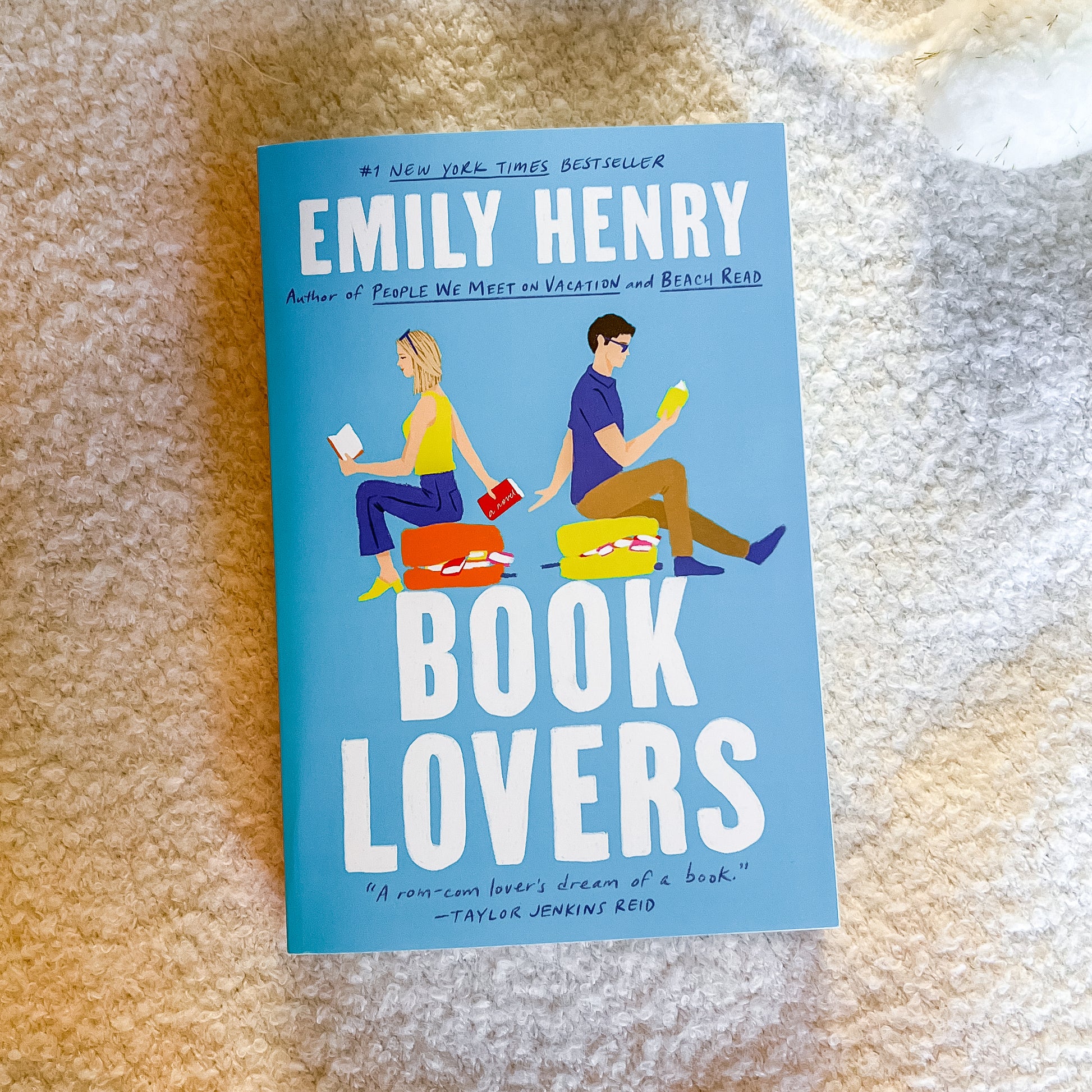 Book cover of 'Book Lovers' by Emily Henry on a textured surface