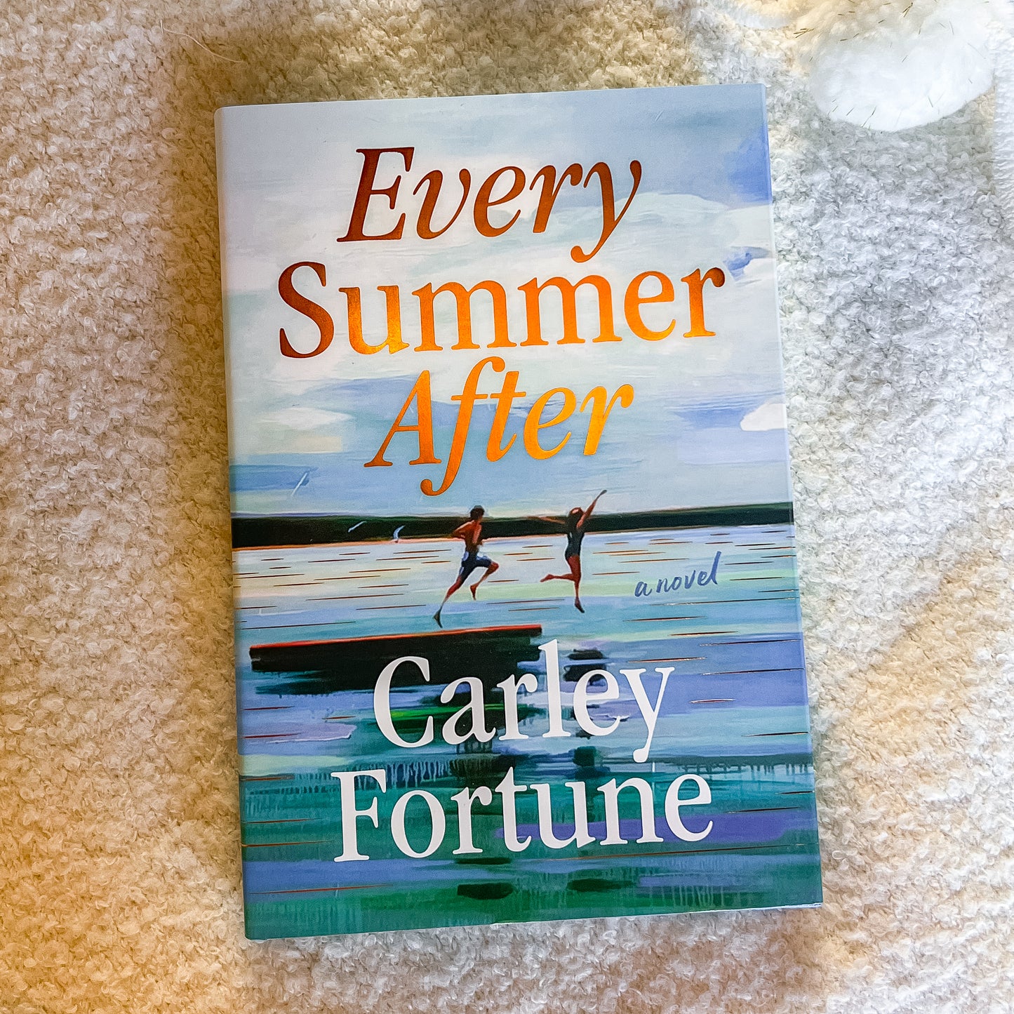 Book titled 'Every Summer After' by Carley Fortune on a textured surface
