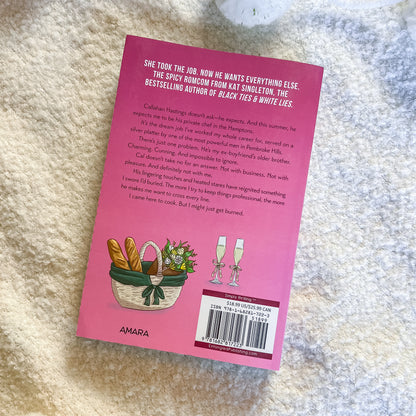 Pink book cover with text and illustrations on a textured surface