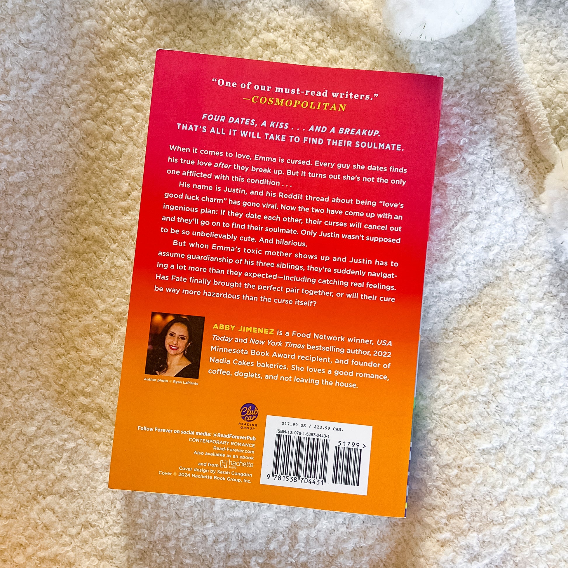 Book back cover with text and a photo of a woman on a beige carpet
