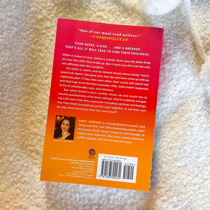 Book back cover with text and a photo of a woman on a beige carpet