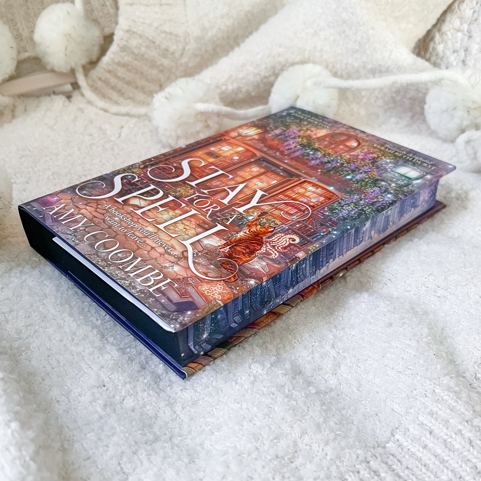 Book titled 'Stay Spell' by Amy Coe on a soft white surface